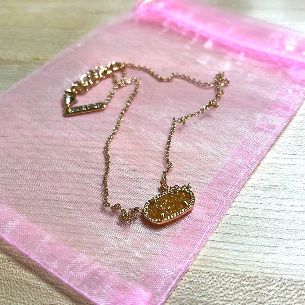 Kendra Scott rose gold necklace.